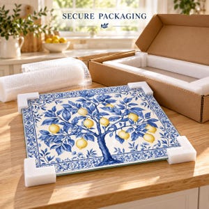 Close-up of the glossy glass edge and blue botanical lemon artwork with its decorative printed border.