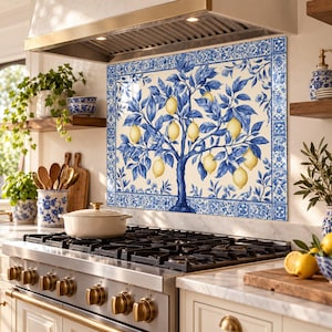 Left-angle view of the lemon tree backsplash above a stove with blue lower cabinets and cream upper cabinets.