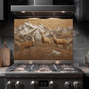 May include: A decorative kitchen backsplash featuring a detailed painting of three deer standing in a field of tall grass, with a mountain range in the background. The color palette includes shades of brown, beige, and gray.