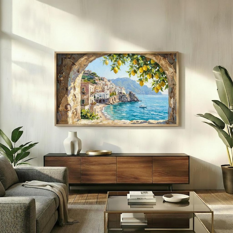May include: A rectangular wall art print featuring a coastal Mediterranean scene viewed through a stone archway. The image displays a hillside village, turquoise water, a small boat, and a branch of yellow lemons hanging in the foreground.