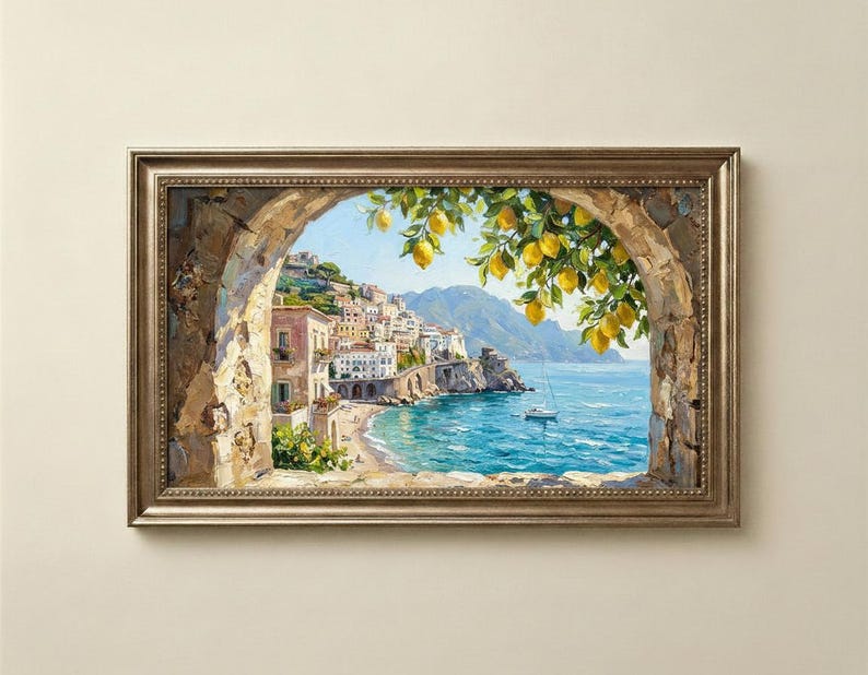 May include: A framed landscape painting depicting a coastal town with white buildings nestled on a cliffside overlooking a blue sea. A stone archway frames the scene, with bright yellow lemons hanging from green branches in the foreground.