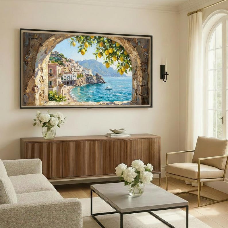 May include: A rectangular wall art print featuring a coastal Mediterranean scene viewed through a stone archway. The painting depicts a seaside town with white buildings, a blue ocean, and a lemon tree branch with yellow fruit in the foreground.