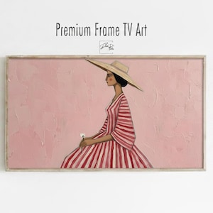 Puede incluir: Una pieza de arte mural rectangular enmarcada titulada Premium Frame TV Art que presenta una ilustración estilizada de una persona con un sombrero de paja de ala ancha y un vestido a rayas rojas y blancas, sosteniendo una pequeña flor blanca sobre un fondo rosa texturizado.