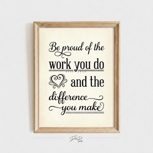 May include: A framed wall art print featuring black text on a cream background that reads: Be proud of the work you do and the difference you make. The design includes decorative flourishes and a heart icon, all enclosed in a light wood frame.