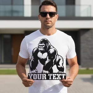 A man wearing a white t-shirt with a graphic of a gorilla and holding a sign that says "YOUR TEXT".