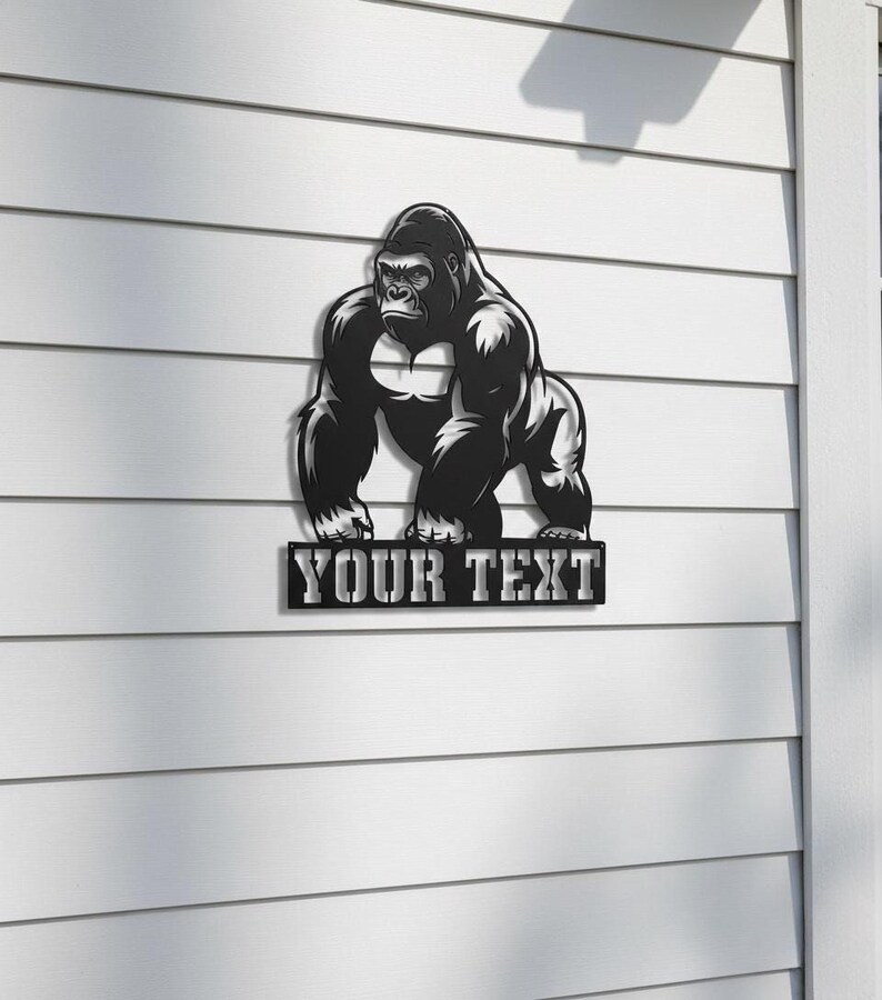 A black and white illustration of a gorilla is mounted on a white wall, with the text "YOUR TEXT" below it.
