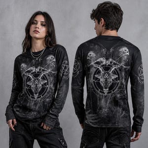 May include: A black long-sleeve shirt featuring a white graphic print of a goat head centered within a pentagram. The design includes smoke-like patterns, skulls, and additional pentagram symbols on the sleeves and chest area, set against a dark background.
