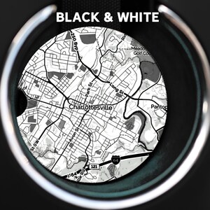 May include: Black and white map of Charlottesville, Virginia, with the text "BLACK & WHITE" at the top. The map is in a car cup holder.