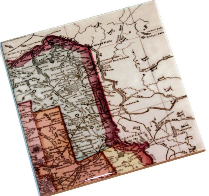 May include: An antique map of the United States, showing the states of Minnesota, Wisconsin, Iowa, Illinois, Michigan, and parts of New York and Pennsylvania. The map is printed on a white background with brown lines and text. The states are outlined in red and pink.