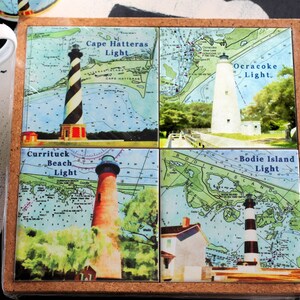 May include: Set of four cork-backed coasters featuring nautical maps with lighthouses. The coasters feature the names "Cape Hatteras Light", "Ocracoke Light", "Currituck Beach Light", and "Bodie Island Light".