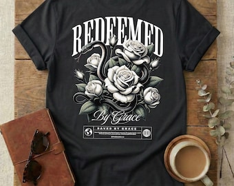 Camiseta Amazing Grace redimida por la gracia con flores de primavera y la frase "Jesús salvó a Efesios 2:8, hijo de Dios, vida eterna", diseño cristiano popular.