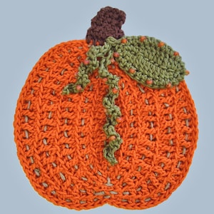 May include: A handmade, orange crochet pumpkin with a brown stem and green leaf. The pumpkin has a textured surface and is decorated with a green vine and small orange beads. This decorative item is perfect for fall and autumn decor.