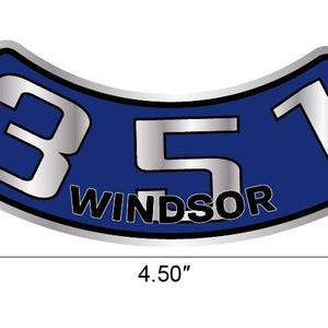 May include: A curved, blue and silver emblem with the text "351 Windsor". The emblem is 11.43 cm wide. The numbers and text are silver with a black outline. The background is blue with a silver border.