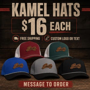May include: Five baseball caps in maroon, dark green, blue, grey, and black. Each cap features a brown leather-like patch with the script text Smith's. The caps have a structured front, mesh or perforated side panels, and a decorative rope trim.