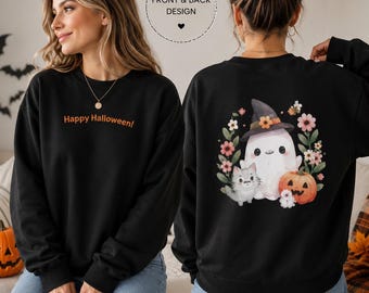 May include: A black long-sleeve sweatshirt featuring the orange text Happy Halloween on the front. The back displays a graphic of a white ghost wearing a witch hat, a grey cat, a pumpkin, and colorful flowers arranged in a circular wreath design.