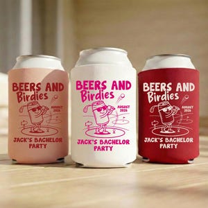 May include: Three beverage can coolers in pink, white, and red. Each cooler has the text "BEERS AND Birdies" and "Jack's Bachelor Party" with a cartoon beer can golfing. The date "August 2026" is also printed.