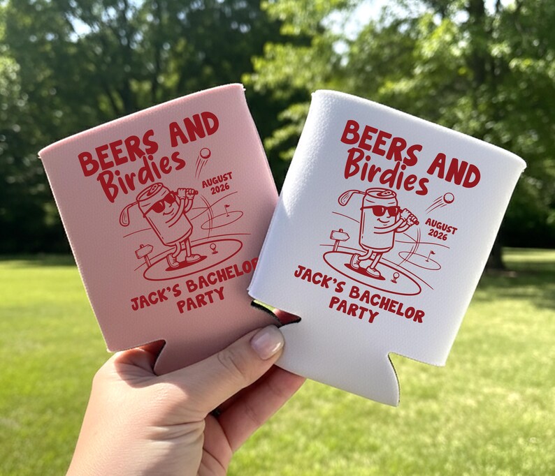 May include: Two beverage insulators, one pink and one white, with the text "BEERS AND Birdies" and "JACK'S BACHELOR PARTY" in red. Each features a cartoon can playing golf, with the date "AUGUST 2026".