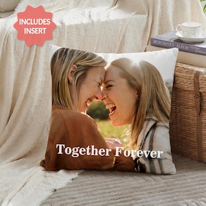 May include: Square throw pillow featuring a photo of two women laughing with the text "Together Forever" in white. The pillow has a white background and includes an insert. The women are wearing brown and plaid tops.