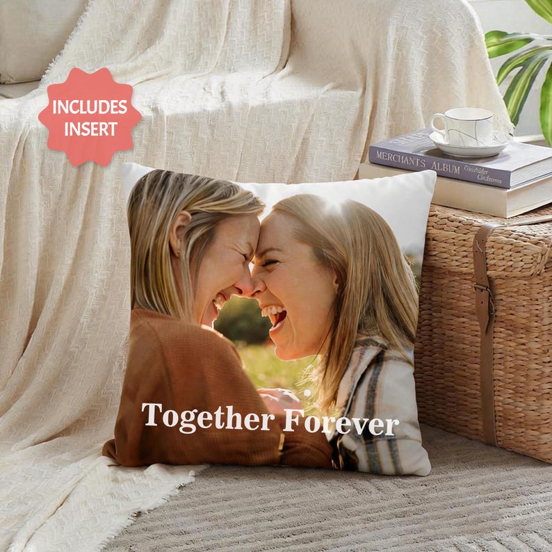 May include: Square white pillow with a photo of two women laughing, their foreheads touching. The words "Together Forever" are printed in white. The pillow includes an insert.