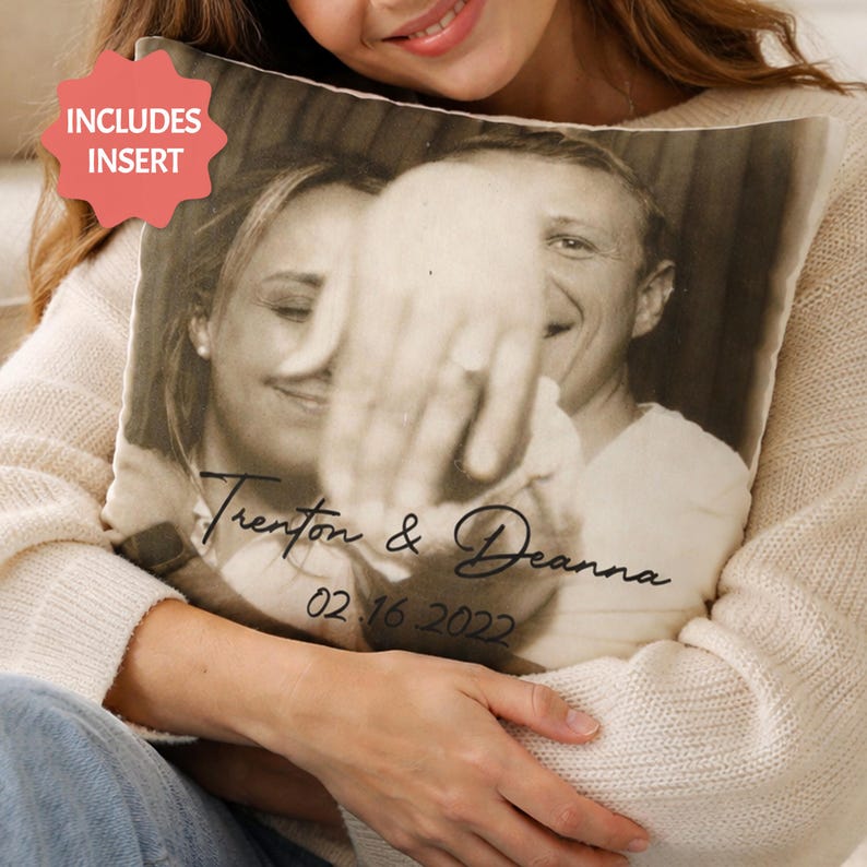 May include: A square pillow with a black and white photograph of a couple, with the names "Trenton & Deanna" and the date "02.16.2022" printed on it. The pillow includes an insert.