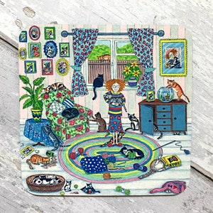 May include: A colourful illustration of a woman surrounded by cats in a room with a floral rug, a window, and a dresser. The woman is holding a cat and there are many cats throughout the room, including on the furniture, on the floor, and in a fishbowl. The text "CATS" is visible on a box in the bottom right corner of the image.