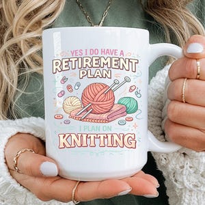 May include: White ceramic mug with the text "YES I DO HAVE A RETIREMENT PLAN I PLAN ON KNITTING". The mug features illustrations of yarn balls, knitting needles, and buttons in pastel colors. A perfect gift for knitters.