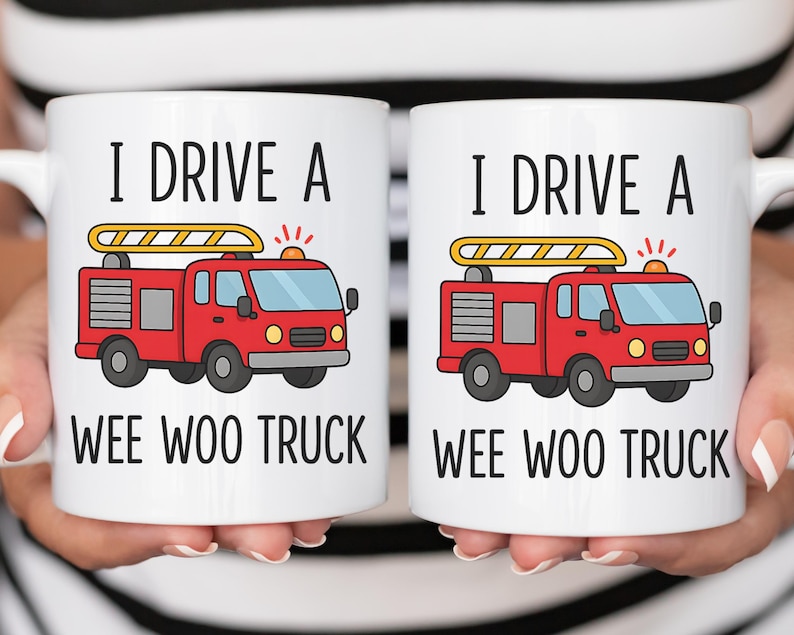 May include: Two white ceramic mugs with the text "I DRIVE A WEE WOO TRUCK" and a red fire truck graphic. The fire truck has a yellow ladder on top and is set against a white background.