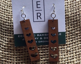 Rectangle wood earrings with heart cut outs. All items ship in cute cloth bag.