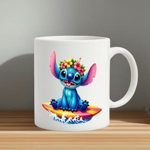May include: White ceramic mug featuring a cartoon character, Stitch, sitting on a surfboard. Stitch is blue with large ears and a floral crown. The surfboard is yellow, pink, and orange, with blue waves below.