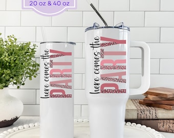 May include: White tumblers with the text "here comes the PARTY" in pink and leopard print. One tumbler is tall and slender, the other is wider with a handle. The text "Tumblers available in 20 oz & 40 oz" is in the top left.