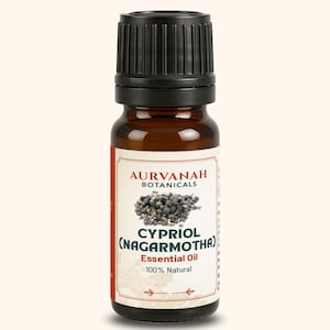 May include: A brown glass bottle of Cypriol (Nagarmotha) essential oil with a black cap. The label features the brand name "Aurvanah Botanicals" and the words "Essential Oil 100% Natural."