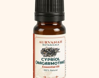 May include: A brown glass bottle of Cypriol (Nagarmotha) essential oil with a black cap. The label features the brand name "Aurvanah Botanicals" and the words "Essential Oil 100% Natural."