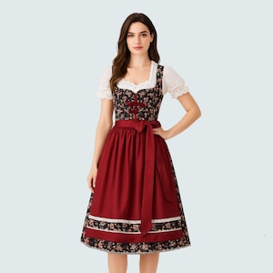 May include: A traditional dirndl dress featuring a black floral bodice, a red skirt, and a white blouse with lace trim. The dress has a red ribbon tied at the waist and floral trim at the hem. A classic German and Austrian folk dress.