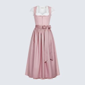 May include: A traditional pink dirndl dress with a white lace-trimmed bodice and short sleeves. The dress features a fitted bodice, a full skirt, and a matching pink bow at the waist. A classic Bavarian style dress.