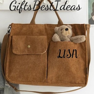 May include: A brown corduroy tote bag with two front pockets and a teddy bear peeking out of one. The bag has a shoulder strap and top handles. The word "LISA" is written on the front pocket. The text "Gifts Best Ideas" is at the top.