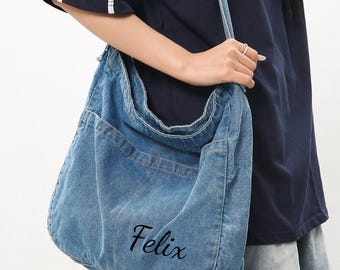 May include: A light blue denim shoulder bag with a large front pocket and a long strap. The bag has the name "Felix" embroidered on the front. The text "Gifts Best Ideas" is visible at the top.