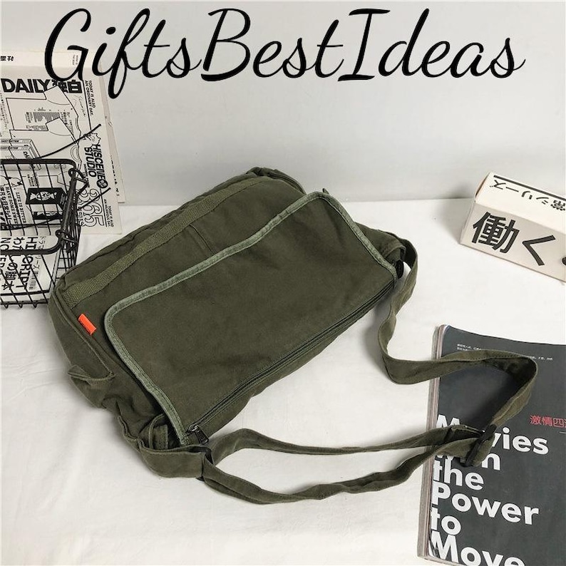 May include: An olive green messenger bag with a long adjustable strap. The bag has a large flap pocket and a zippered main compartment. The text "Gifts Best Ideas" is at the top of the image.
