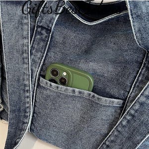 May include: Close-up of a denim tote bag with a pocket. The bag is a medium wash blue with white stitching and straps. A green phone case is visible in the pocket. The text "GiftsBox" is visible at the top.