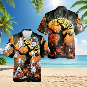 May include: A short-sleeve button-down shirt featuring a Halloween-themed print with white ghosts, orange jack-o'-lanterns, and dark silhouettes of bare trees against a vibrant orange and yellow sunset sky background with a large full moon.