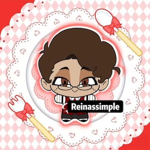 May include: A cartoon illustration of a character with brown hair, glasses, and a red vest. The character is on a white plate with a pink and white checkered background. The text "Reinassimple" is visible. Decorative spoons and forks with red bows are also present.