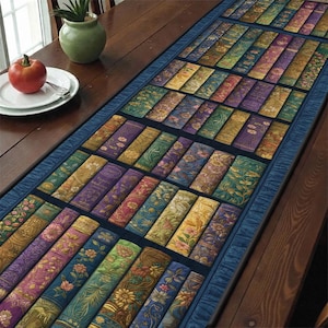 May include: A rectangular table runner featuring a design of stacked, antique-style books. The books have colorful spines in shades of green, purple, gold, and blue, with floral and ornate patterns. The runner is bordered by a dark blue fabric.