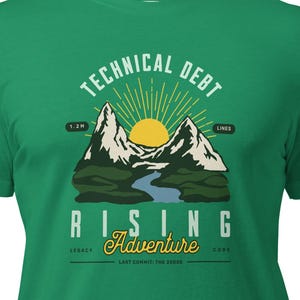 May include: Green t-shirt with a mountain and sun graphic. The text on the shirt reads "TECHNICAL DEBT" above "RISING Adventure". The design includes a river and the words "Legacy", "Adventure", and "Code".
