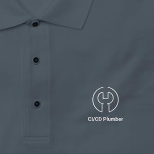 May include: A slate gray polo shirt with a collar and three buttons. The shirt features the "PORT AUTHORITY" brand label and a white logo with the text "CI/CD Plumber" on the right side.