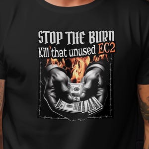 May include: Black t-shirt with the text "STOP THE BURN Kill that unused EC2". The graphic shows hands holding money with flames in the background. The design is enclosed in a barbed wire frame.