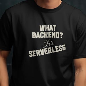 Peut inclure: T-shirt noir avec l'inscription blanche "WHAT BACKEND? It's SERVERLESS". Le t-shirt a un col rond et des manches courtes. La personne porte une montre rouge.