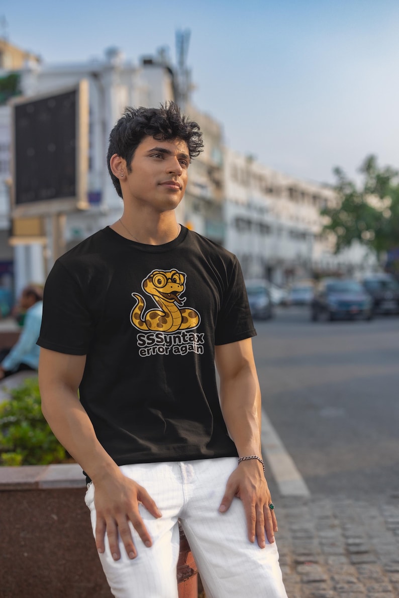 Funny coding t-shirt featuring geeky snake graphic and slogan “SSSyntax Error Again”, gift for software developers and coders