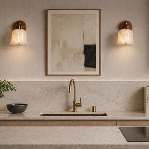 Modern brass wall sconce set with alabaster stone shade, minimalist bedroom wall lighting on grey background Mid century brass wall lights with white alabaster tulip shades, luxury wall sconce pair for bedroom decor Set of two brass wall sconces with natural alabaster shades, elegant modern wall lighting fixture Minimal brass wall lamps with alabaster shade, bedside wall lighting pair on neutral grey wall Luxury brass wall sconce pair with alabaster tulip glass shade, modern wall lighting.
