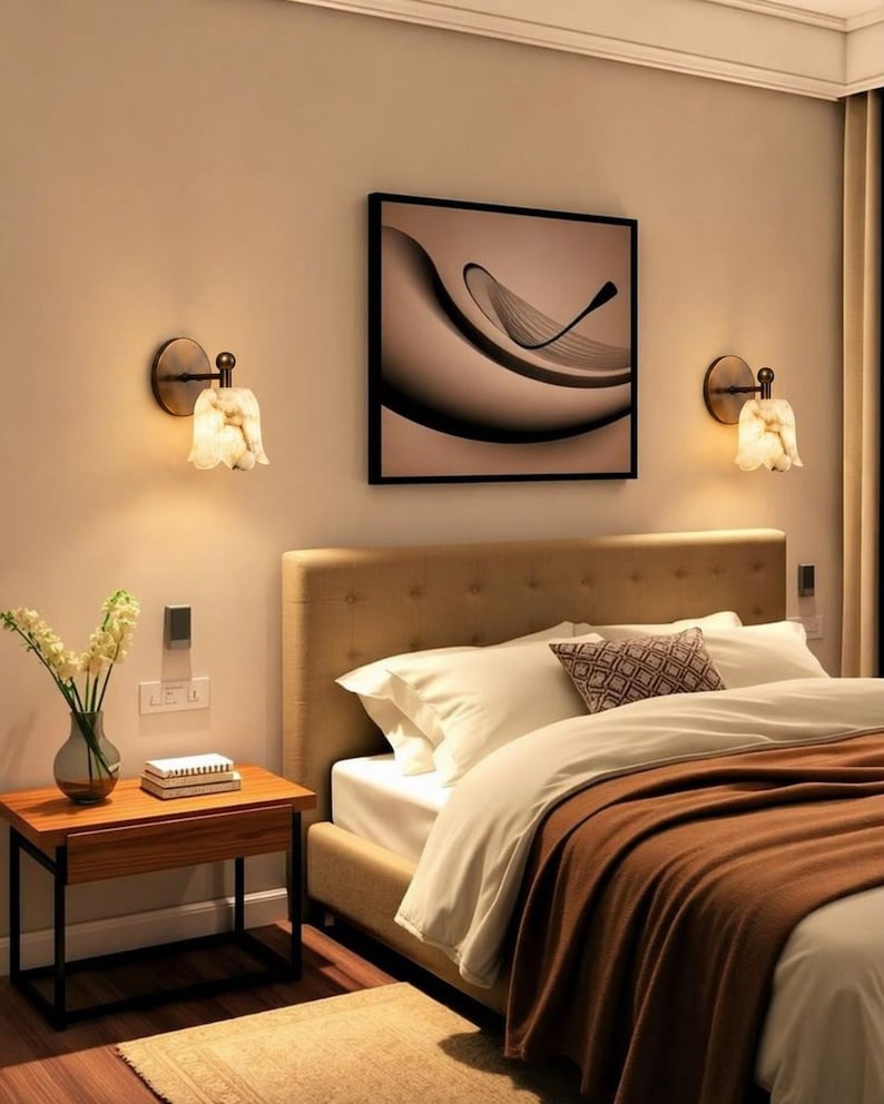 Modern brass wall sconce set with alabaster stone shade, minimalist bedroom wall lighting on grey background Mid century brass wall lights with white alabaster tulip shades, luxury wall sconce pair for bedroom decor Set of two brass wall sconces with natural alabaster shades, elegant modern wall lighting fixture Minimal brass wall lamps with alabaster shade, bedside wall lighting pair on neutral grey wall Luxury brass wall sconce pair with alabaster tulip glass shade, modern wall lighting.