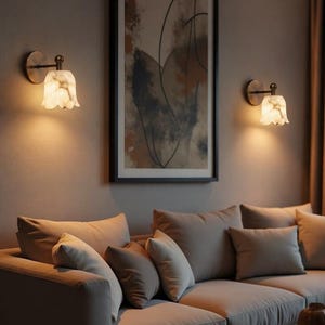 Modern brass wall sconce set with alabaster stone shade, minimalist bedroom wall lighting on grey background Mid century brass wall lights with white alabaster tulip shades, luxury wall sconce pair for bedroom decor Set of two brass wall sconces with natural alabaster shades, elegant modern wall lighting fixture Minimal brass wall lamps with alabaster shade, bedside wall lighting pair on neutral grey wall Luxury brass wall sconce pair with alabaster tulip glass shade, modern wall lighting.