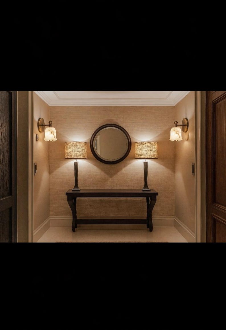 Modern brass wall sconce set with alabaster stone shade, minimalist bedroom wall lighting on grey background Mid century brass wall lights with white alabaster tulip shades, luxury wall sconce pair for bedroom decor Set of two brass wall sconces with natural alabaster shades, elegant modern wall lighting fixture Minimal brass wall lamps with alabaster shade, bedside wall lighting pair on neutral grey wall Luxury brass wall sconce pair with alabaster tulip glass shade, modern wall lighting.